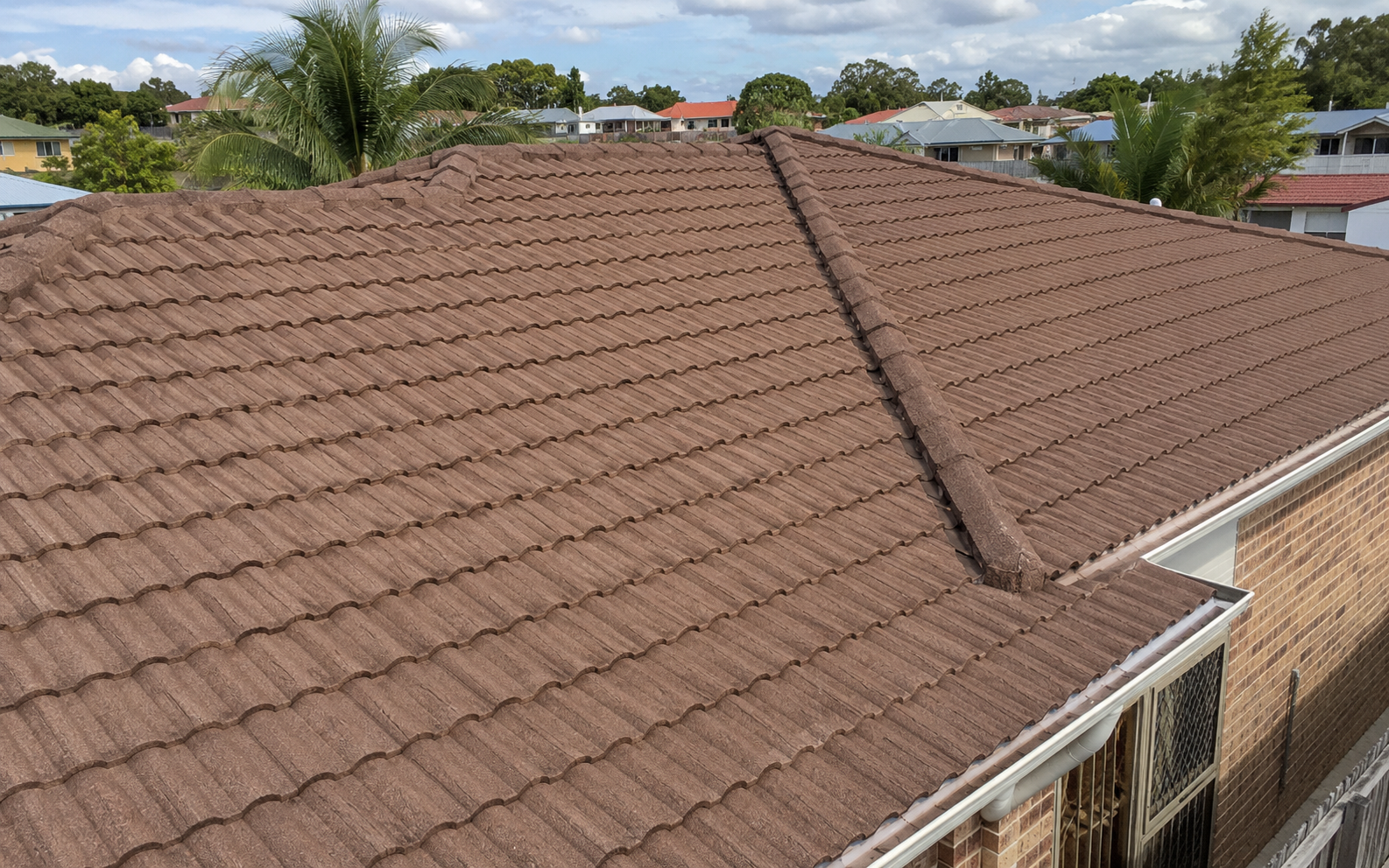 Weathered terracotta tiled roof before professional cleaning