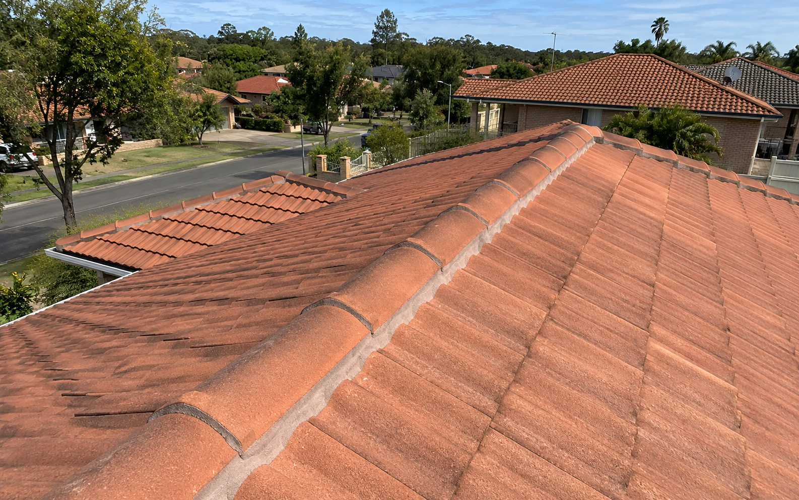 Completed ridge capping repair on terracotta tiled roof