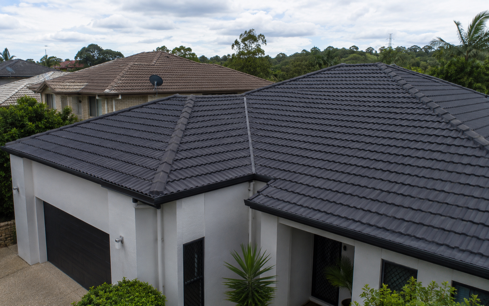 Finished charcoal roof painting result on a tiled Brisbane home